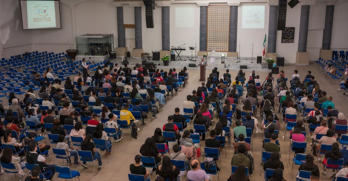 A large audience seated in a church auditorium attending a seminar.
